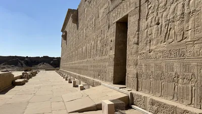 Dendera, Egypt - Feb 10, 2025: Ancient stone reliefs and hieroglyphs carved into the outer wall of the Dendera Temple complex in Egypt.