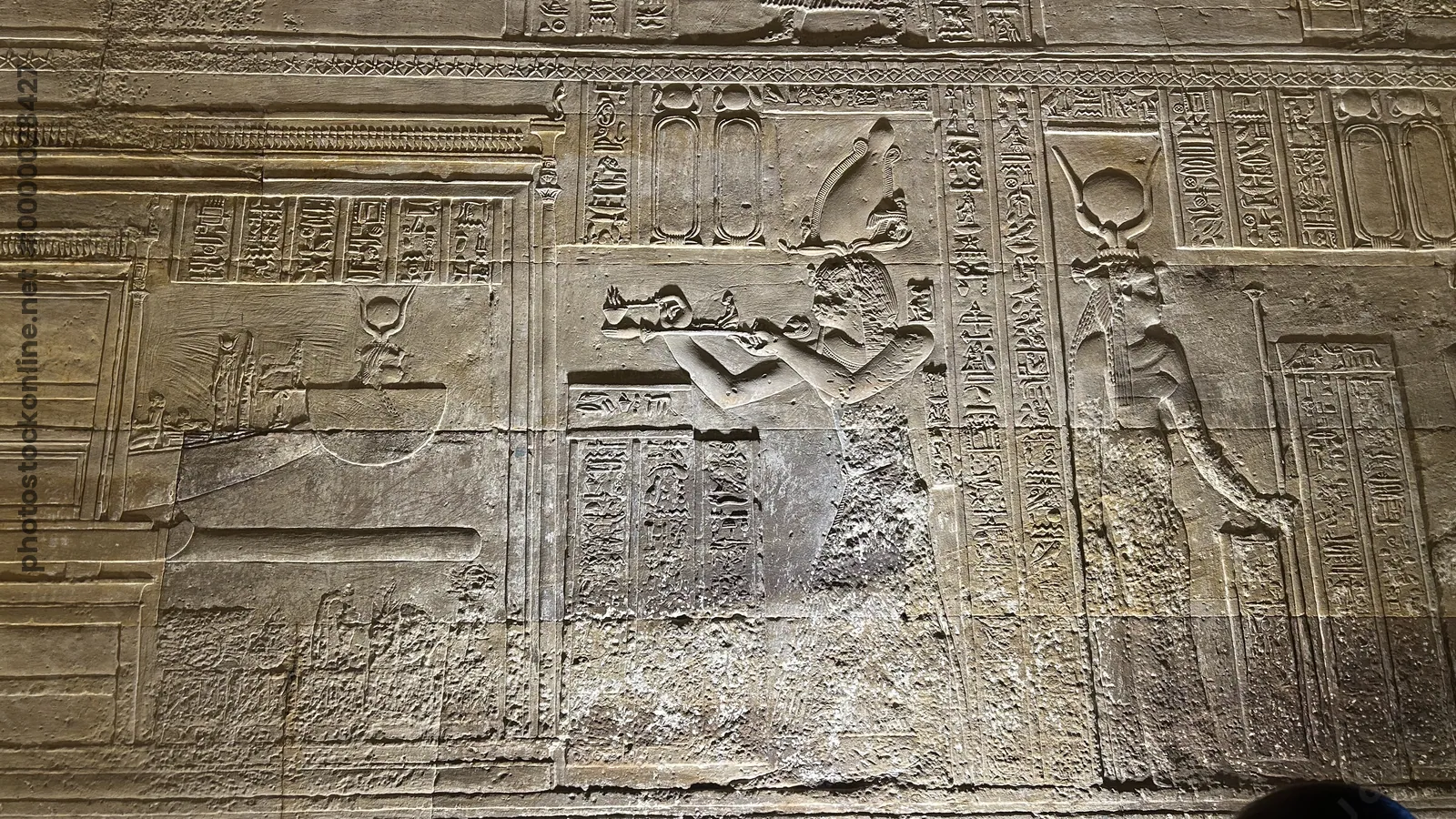 Dendera, Egypt - Feb 10, 2025: Detailed wall relief inside the Temple of Hathor at Dendera showing a pharaoh offering to deities with hieroglyphic ins