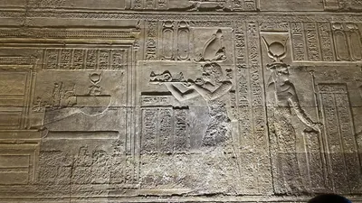 Dendera, Egypt - Feb 10, 2025: Detailed wall relief inside the Temple of Hathor at Dendera showing a pharaoh offering to deities with hieroglyphic ins