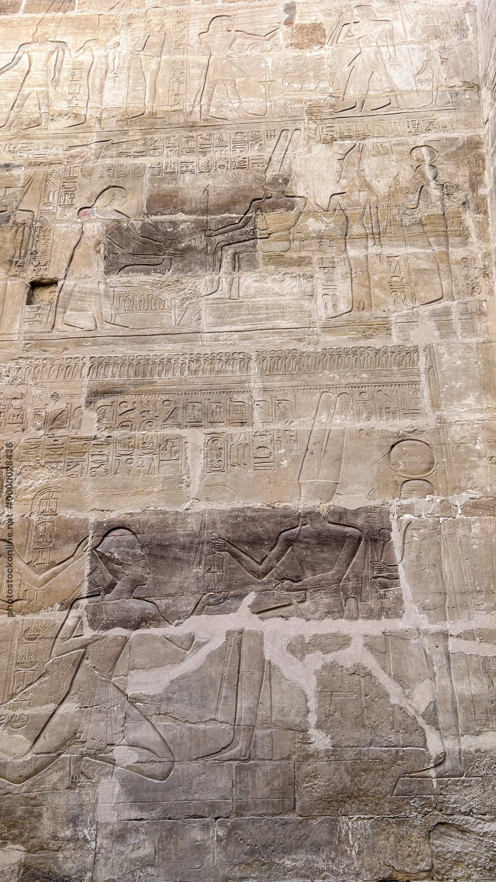 Karnak Temple, Luxor, Egypt - Feb 10, 2025: Ancient stone relief showing figures and hieroglyphics on temple walls, highlighting pharaonic artistry.