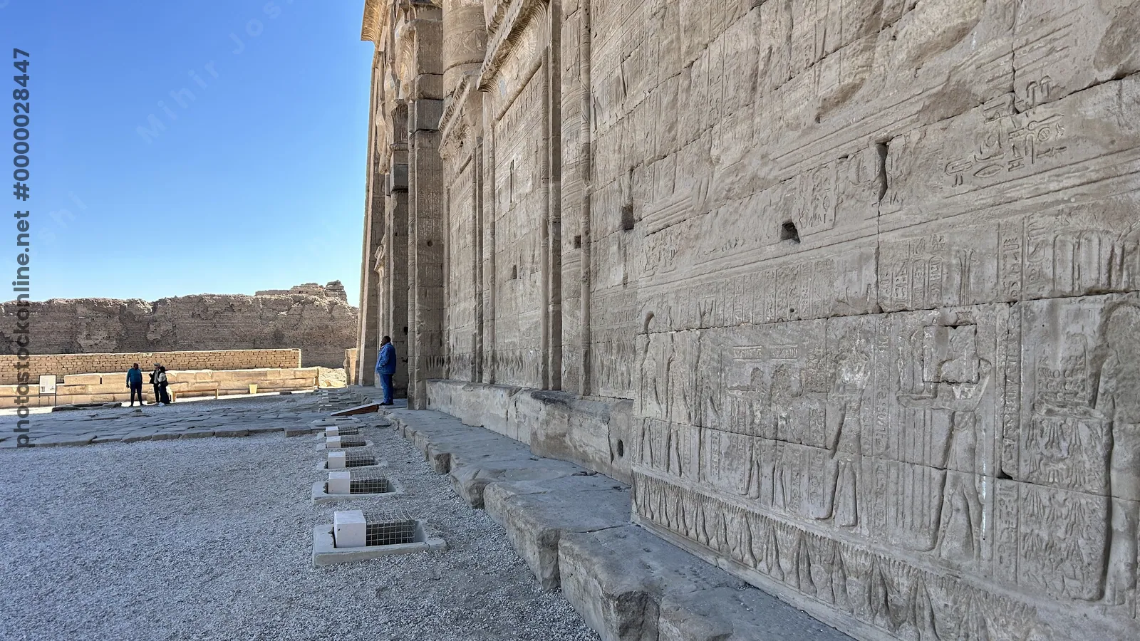 Dendera, Egypt - Feb 10, 2025: Ancient stone reliefs and hieroglyphs carved into the outer wall of the Dendera Temple complex in Egypt.