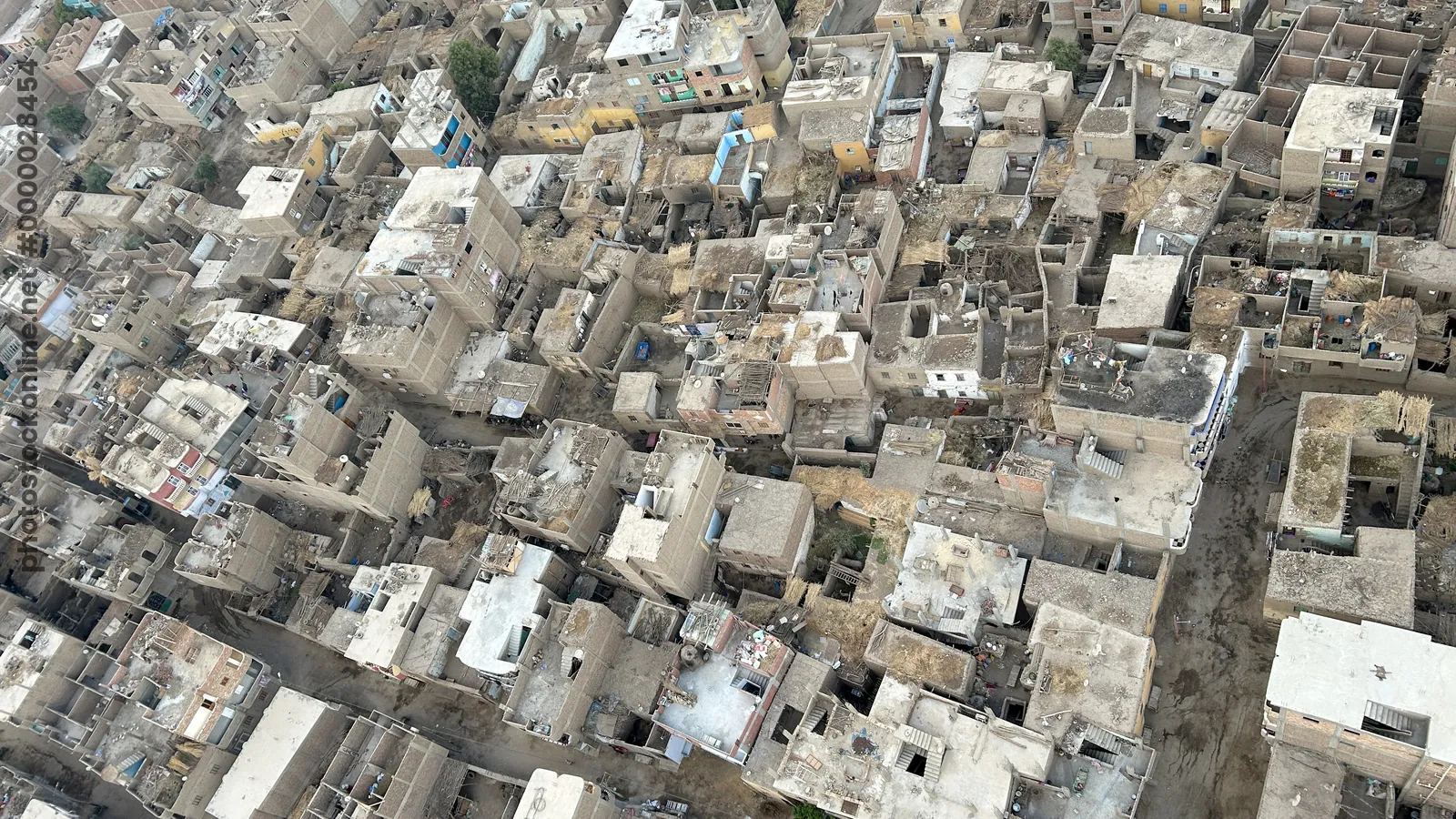 Luxor, Egypt - Feb 10, 2025: Aerial view of dense residential housing and rooftops in Luxor, Egypt, showing traditional urban architecture from a hot