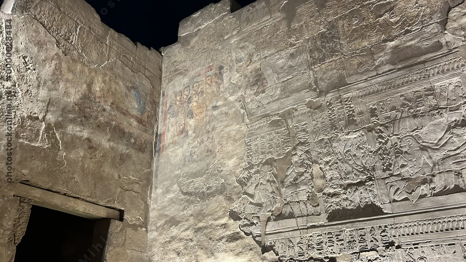 Luxor, Egypt - Feb 9, 2025: Coptic Christian wall painting plastered over ancient Egyptian reliefs, showing layered history of Luxor Temple in Egypt.