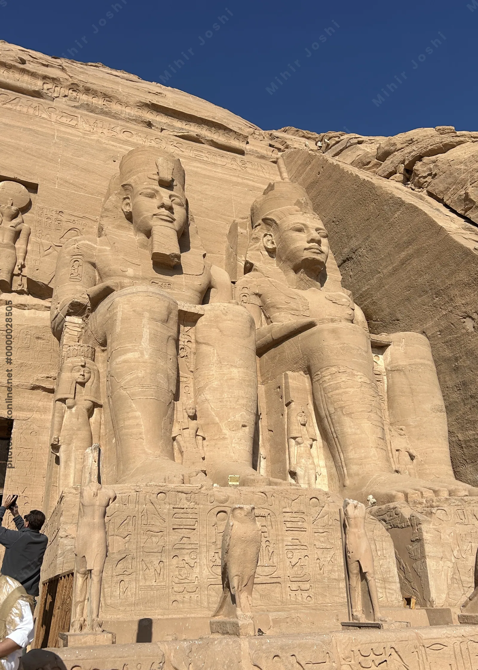 Aswan, Egypt - Feb 8, 2025: Colossal seated statues of Pharaoh Ramesses II at the entrance of the Great Temple of Abu Simbel in Egypt.