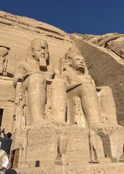 Aswan, Egypt - Feb 8, 2025: Colossal seated statues of Pharaoh Ramesses II at the entrance of the Great Temple of Abu Simbel in Egypt.