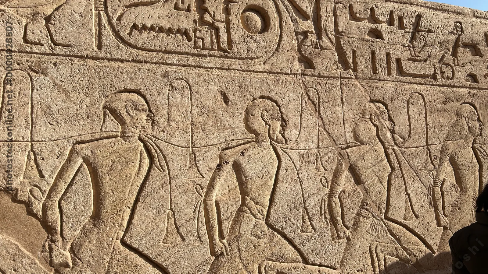 Aswan, Egypt - Feb 8, 2025: Ancient relief at Abu Simbel showing bound captives symbolizing defeated enemies during the reign of Pharaoh Ramesses II.