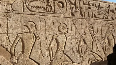 Aswan, Egypt - Feb 8, 2025: Ancient relief at Abu Simbel showing bound captives symbolizing defeated enemies during the reign of Pharaoh Ramesses II.