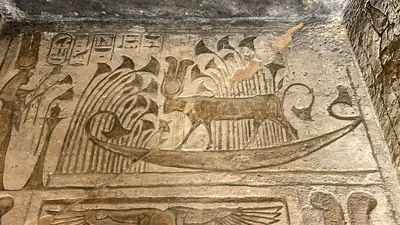 Aswan, Egypt - Feb 8, 2025: Ancient relief at Abu Simbel showing Hathor as a sacred cow with sun disk, sailing in the solar barque.