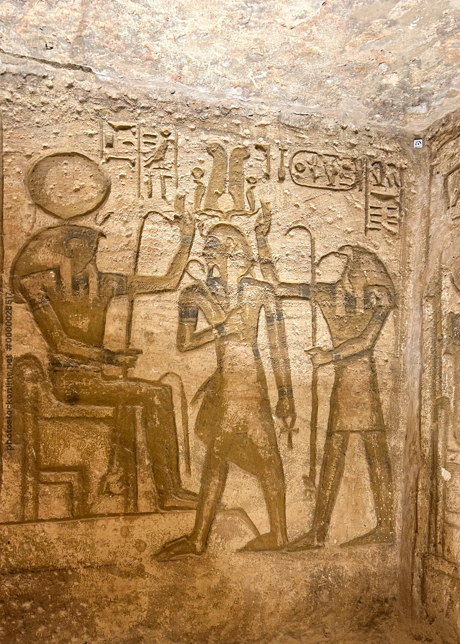 Aswan, Egypt - Feb 8, 2025: Ancient wall relief at Abu Simbel showing Pharaoh with Egyptian deities and hieroglyphs.