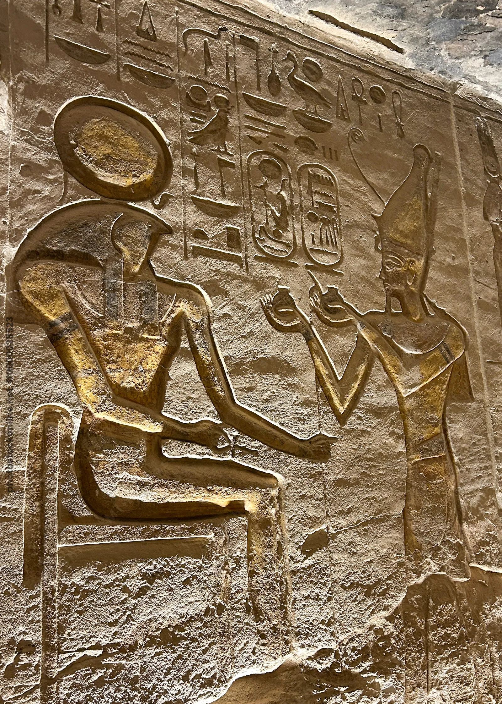 Ancient Egyptian wall carving depicting Pharaoh Ramses II making offerings to the sun god Ra-Horakhty at Abu Simbel, Egypt.