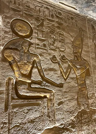 Ancient Egyptian wall carving depicting Pharaoh Ramses II making offerings to the sun god Ra-Horakhty at Abu Simbel, Egypt.