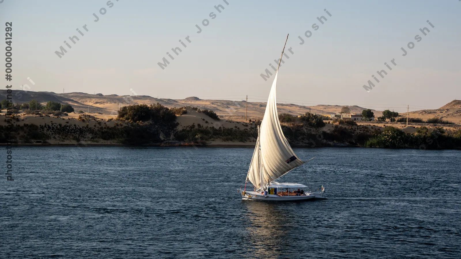 Felucca sailing on the blue waters of the Nile Ri