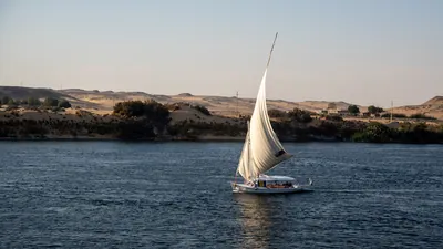 Felucca sailing on the blue waters of the Nile Ri