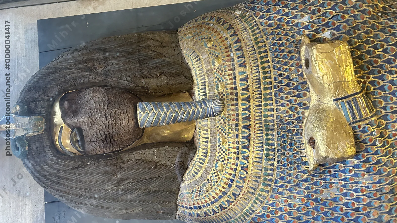 Cairo, Egypt -  Feb 4, 2025: Gilded coffin from KV55 with defaced face and cartouche, likely belonging to Akhenaten, displayed at the Egyptian Museum of Antiquities in Cairo.
