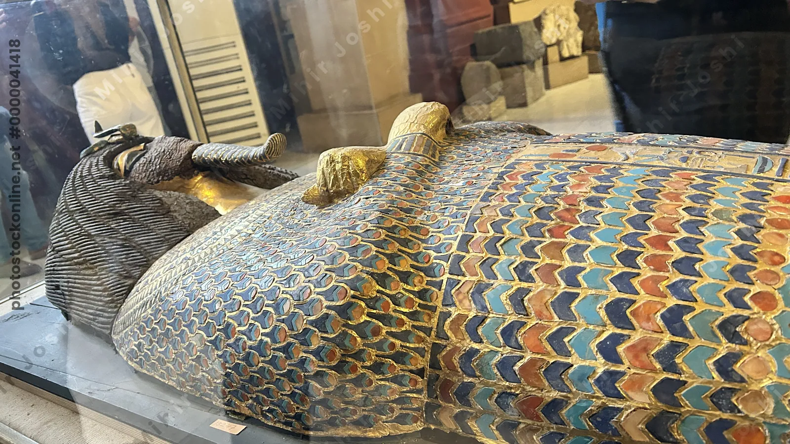 Cairo, Egypt -  Feb 4, 2025: Gilded coffin from KV55 with defaced face and cartouche, likely belonging to Akhenaten, displayed at the Egyptian Museum of Antiquities in Cairo.