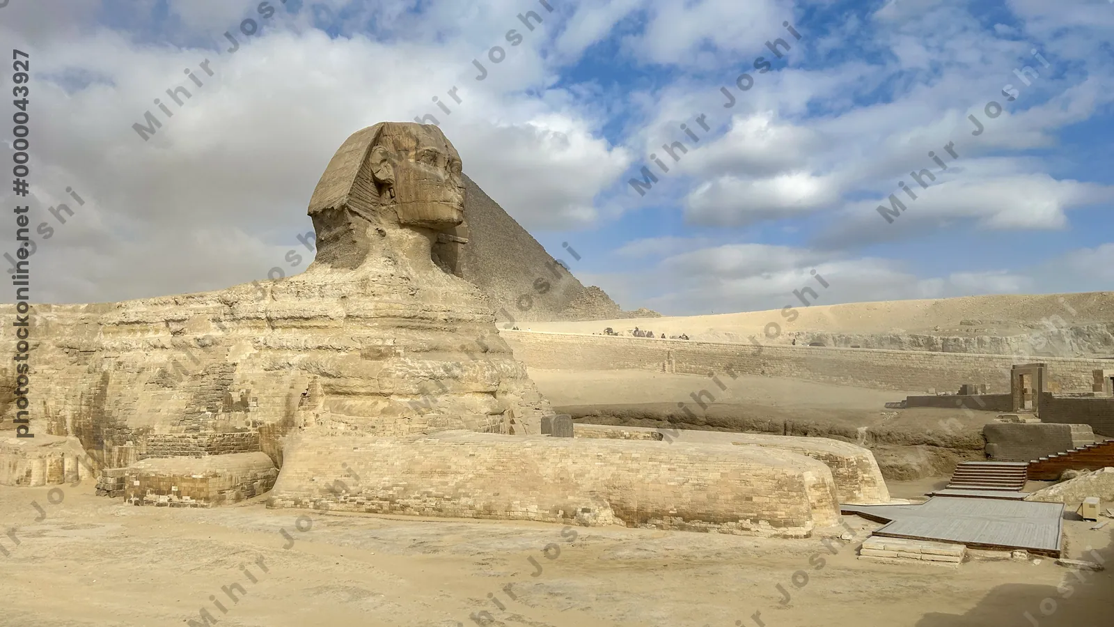 Giza, Egypt - Feb 6, 2025: The Great Sphinx of Giza with the iconic Great Pyramid in the background, a timeless view of ancient Egyptian grandeur.