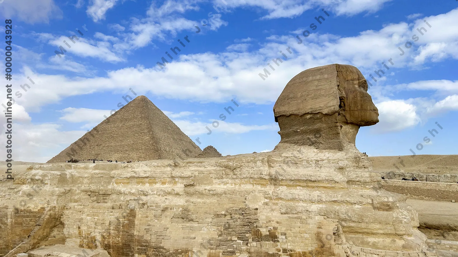 Giza, Egypt - Feb 6, 2025: The Great Sphinx of Giza with the iconic Great Pyramid in the background, a timeless view of ancient Egyptian grandeur.