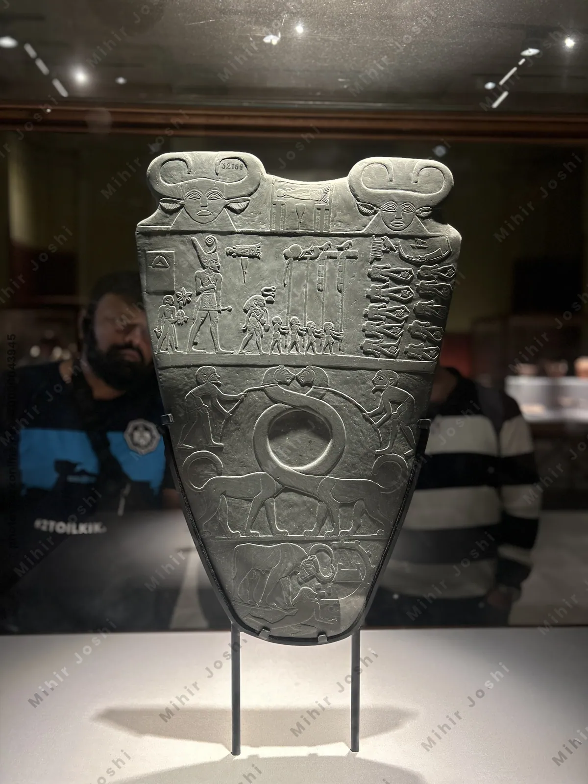 Cairo, Egypt -  Feb 4, 2025: The Narmer Palette, an iconic artifact from 31st century BC Egypt, symbolizing unification of Upper and Lower Egypt. On display in Cairo.