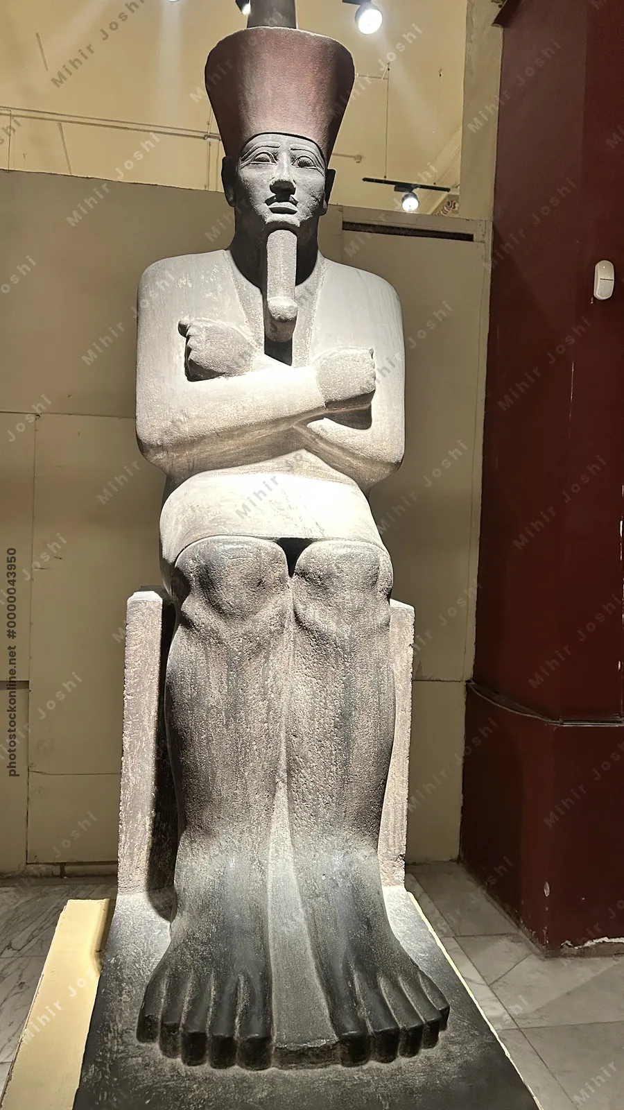 Cairo, Egypt -  Feb 4, 2025: Seated statue of Pharaoh Nebhepetre Mentuhotep II, reunifier of Egypt, on display at the Egyptian Museum in Cairo.