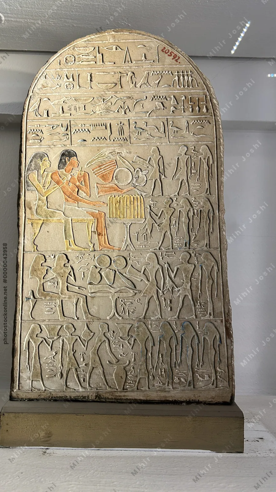 Cairo, Egypt -  Feb 4, 2025: Ancient Egyptian painted limestone stela with hieroglyphs and offering scene, displayed at the Egyptian Museum in Cairo.