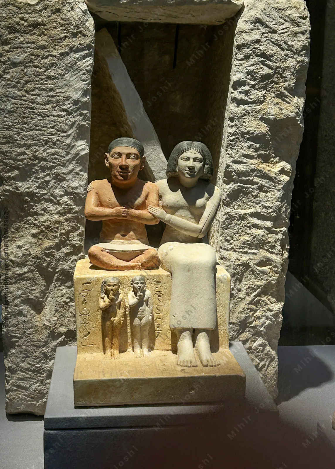 Cairo, Egypt -  Feb 4, 2025: Statue of dwarf Seneb with his wife and children, portraying dignity and family life in ancient Egypt. On display at the Egyptian Museum in Cairo.