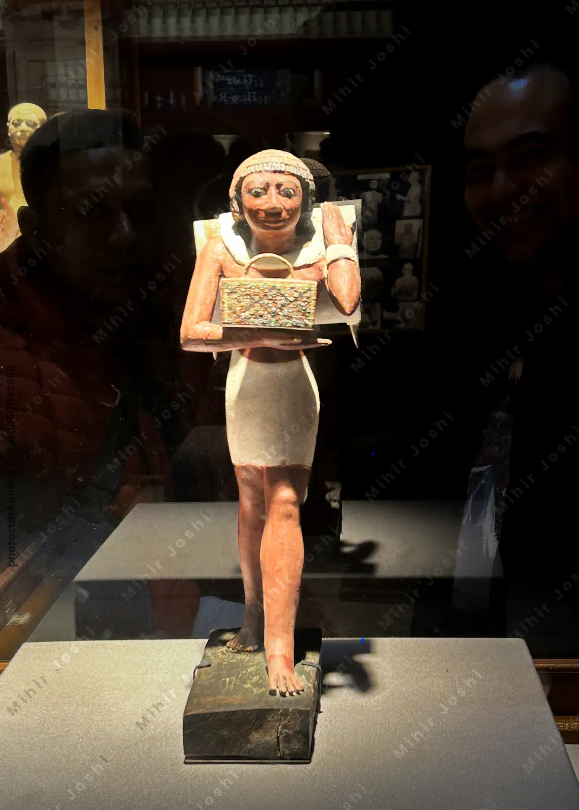 Cairo, Egypt -  Feb 4, 2025: Striding statue of the porter, Niankhpepikem, carrying a back pack and a basket.