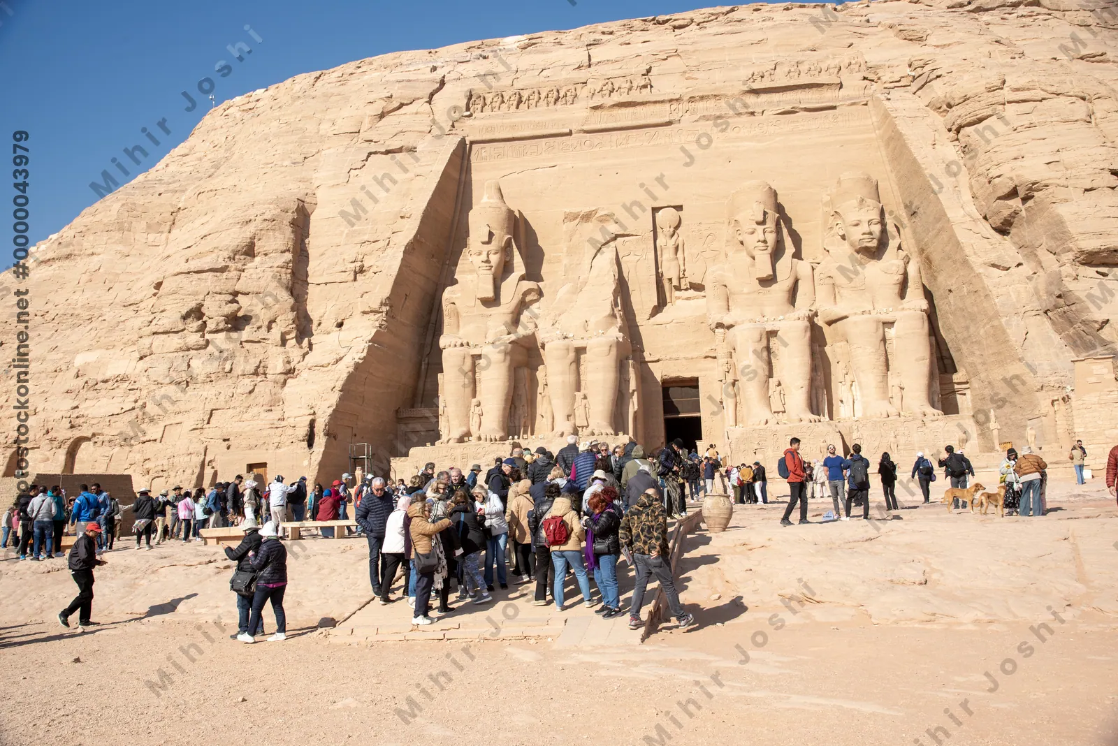 Abu Simbel, Egypt - Feb 8, 2025:  Tourists at the Temple of Ramesses II, Abu Simbel, Egypt, with colossal statues at the entrance.