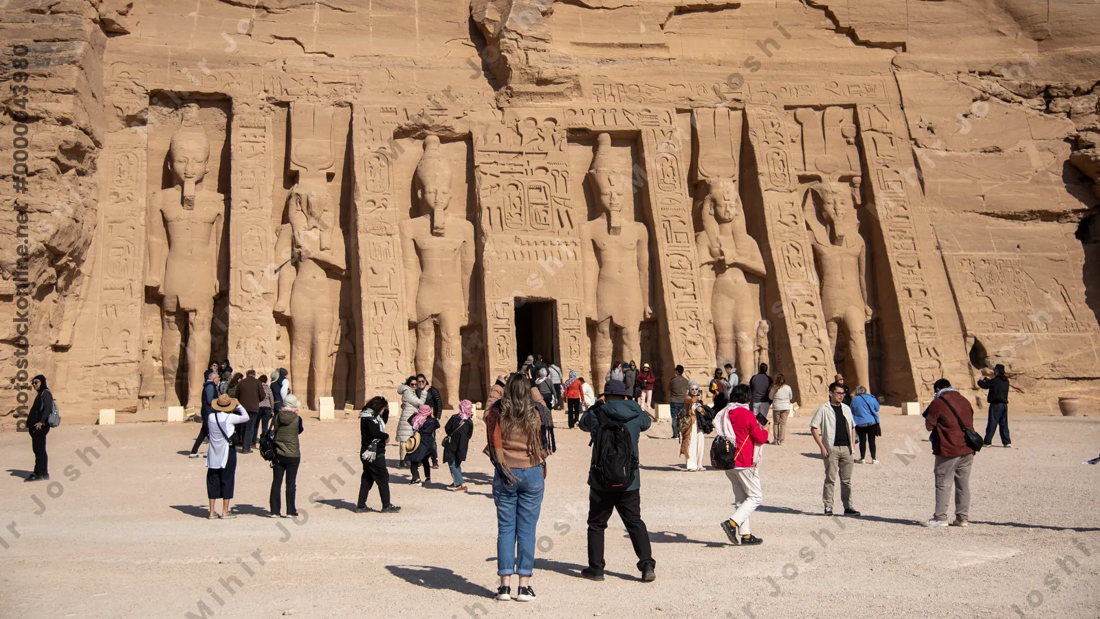 Abu Simbel, Egypt - Feb 8, 2025:  Temple at Abu Simbel dedicated to Queen Nefertari and Hathor, with rock-cut statues and intricate carvings on the facade