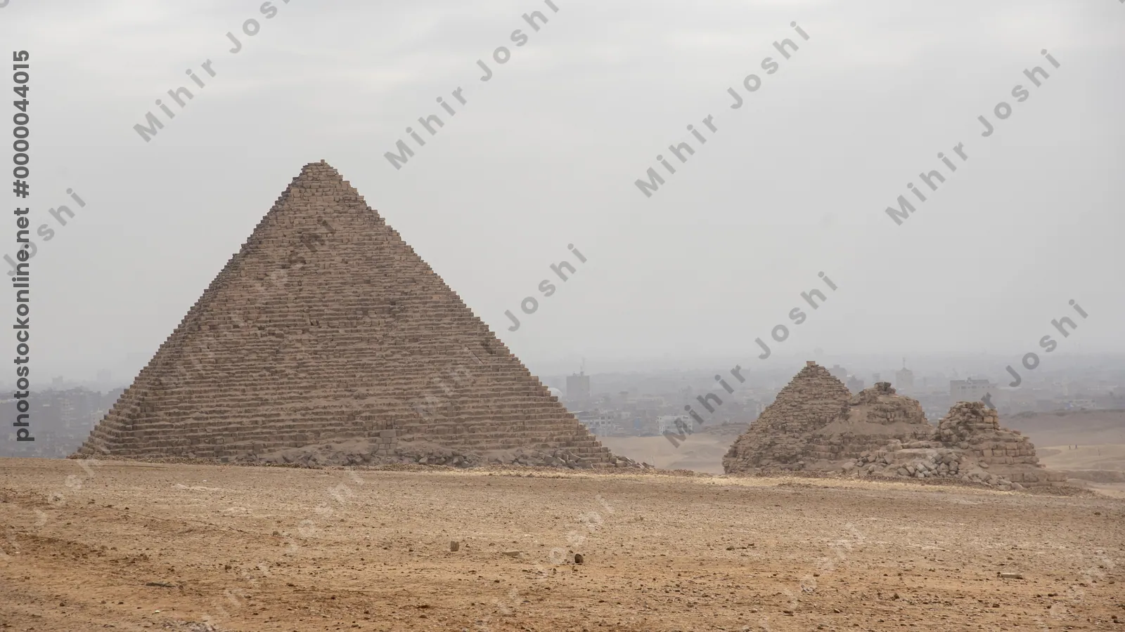 Giza, Egypt - Feb 6, 2024: Sunlight filtering through dramatic clouds, casting rays on the ancient pyramids of Giza in Egypt, creating a stunning natural spotlight effect.