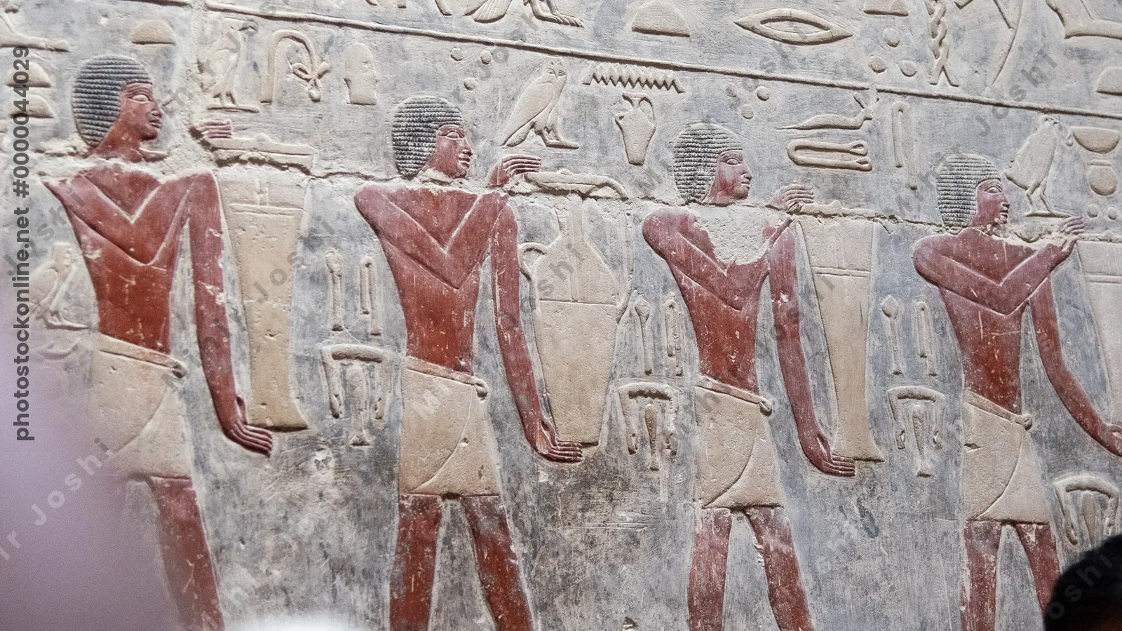 Saqqara, Egypt - Feb 5, 2024: Wall fresco of men carrying jars of provisions for afterlife in tomb of Kagemni, vizier of Pharaoh Teti, Saqqara, Egypt, Old Kingdom.