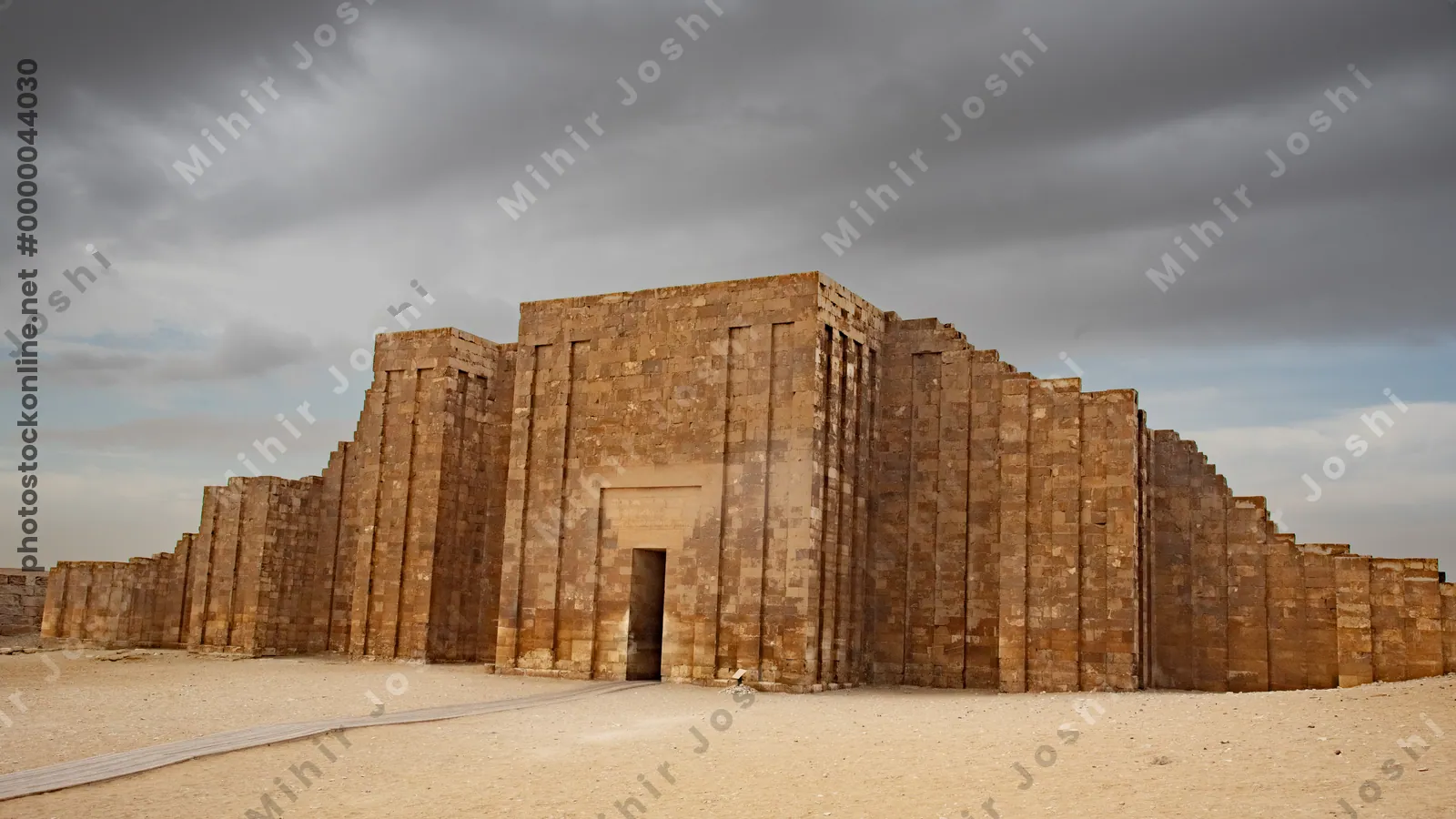 Saqqara,Egypt - Feb 5, 2024: Massive limestone enclosure wall of the Step Pyramid complex at Saqqara, part of the ancient necropolis near Memphis, Egypt.