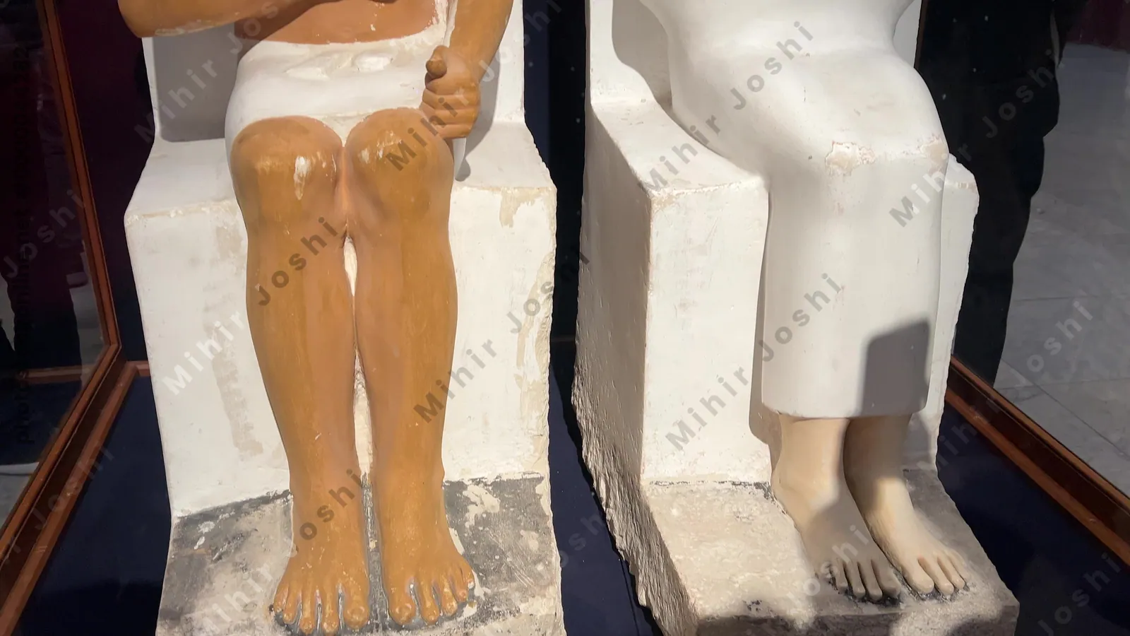 Cairo, Egypt - Feb 4, 2024: painted limestone statues of Prince Rahotep and his wife Nofret in Egyptian Museum in Cairo
