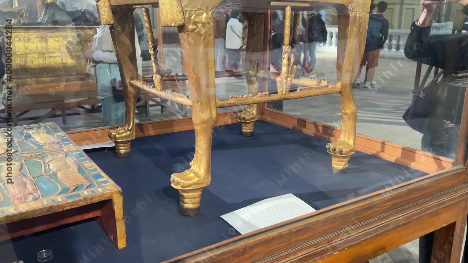 Cairo, Egypt - Feb 4, 2024: Elaborately decorated golden throne of Pharaoh Tutankhamun with inlays and intimate royal scene, displayed at the Egyptian Museum in Cairo.