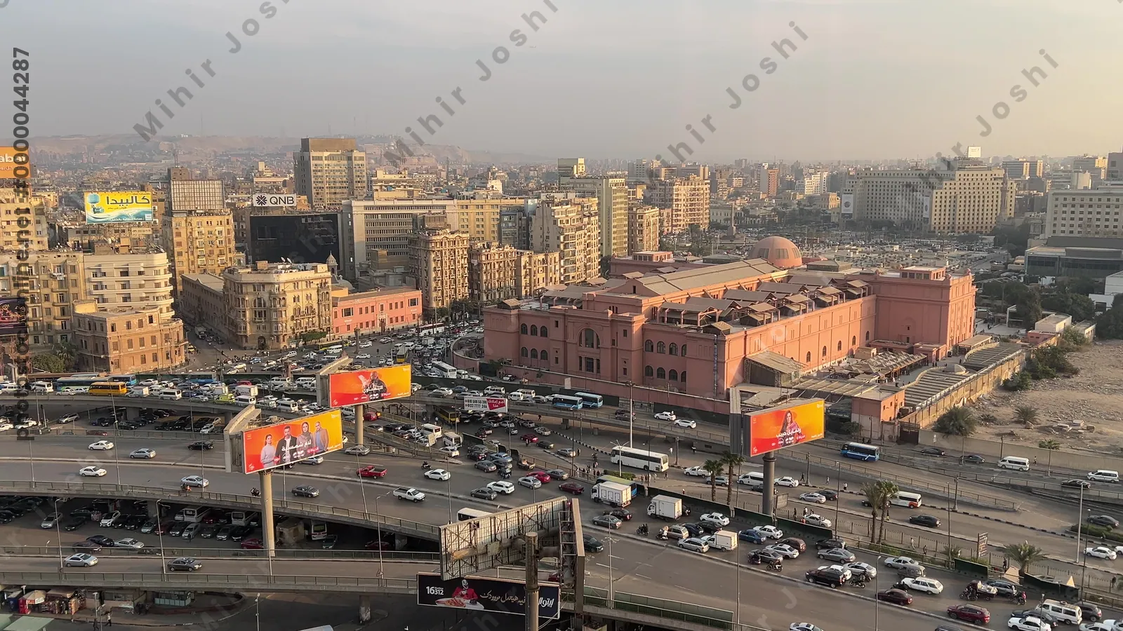 Cairo, Egypt - Feb 4, 2024: Aerial footage of Cairo, Egypt in early evening showing dense traffic, warm city tones, and the bustling movement of a typical rush hour.