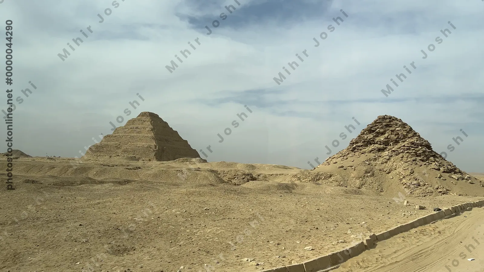 Saqqara, Egypt - Feb 5, 2024: Experience the majestic Step Pyramid and the Pyramid of Userkaf as seen from a bus ride through the ancient necropolis of Saqqara, Egypt.