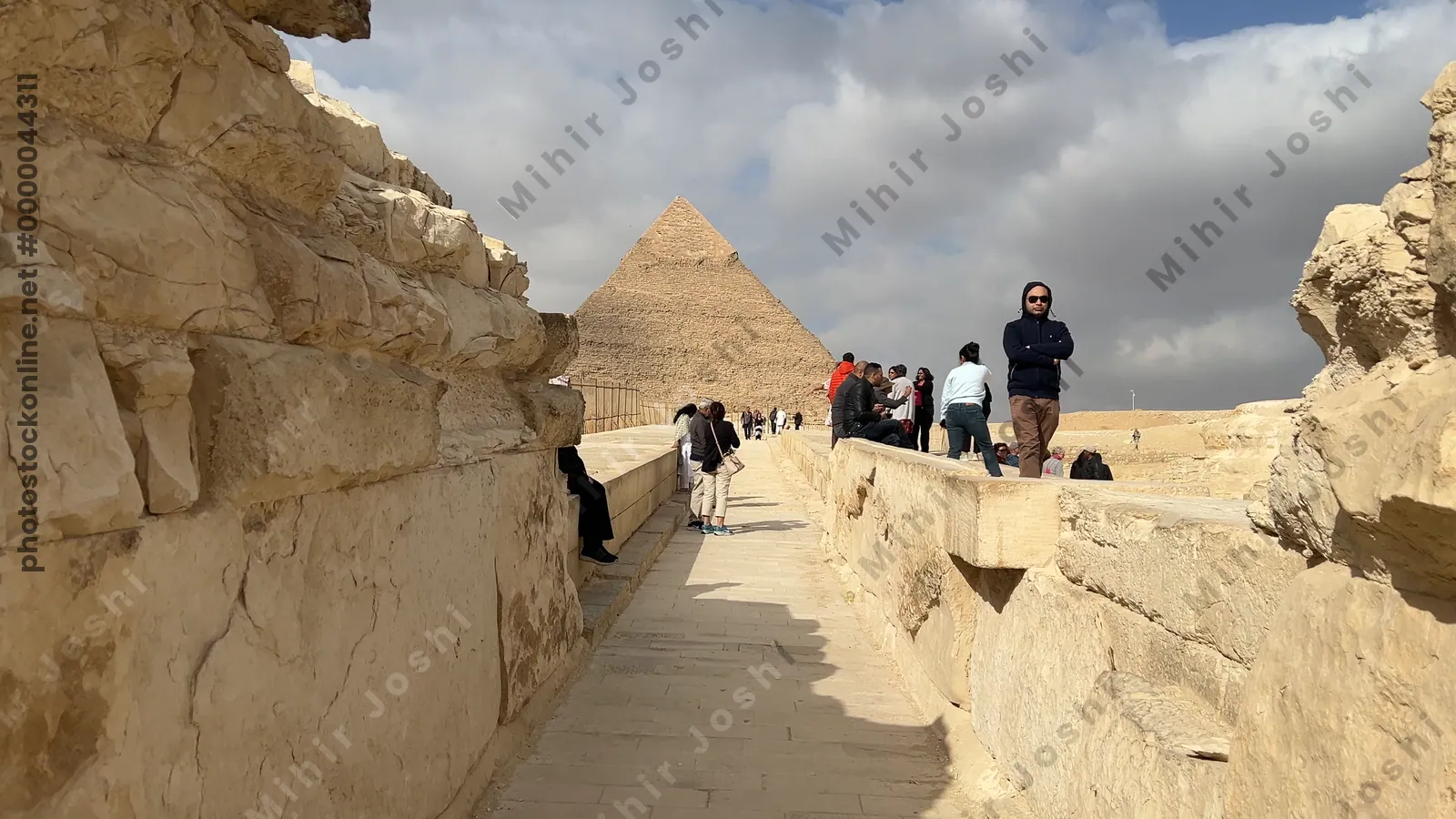 Giza, Egypt - Feb 5, 2025: Panoramic view of the Great Sphinx and Pyramids of Giza from the visitor pathway at the Giza Plateau, Egypt.