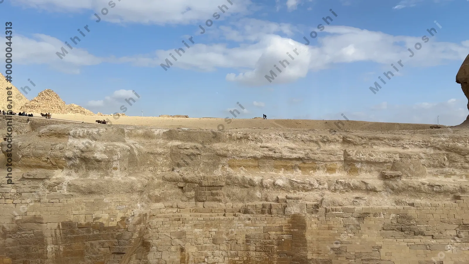 Giza, Egypt - Feb 5, 2025: Panoramic view of the Great Sphinx and Pyramids of Giza from the visitor pathway at the Giza Plateau, Egypt.