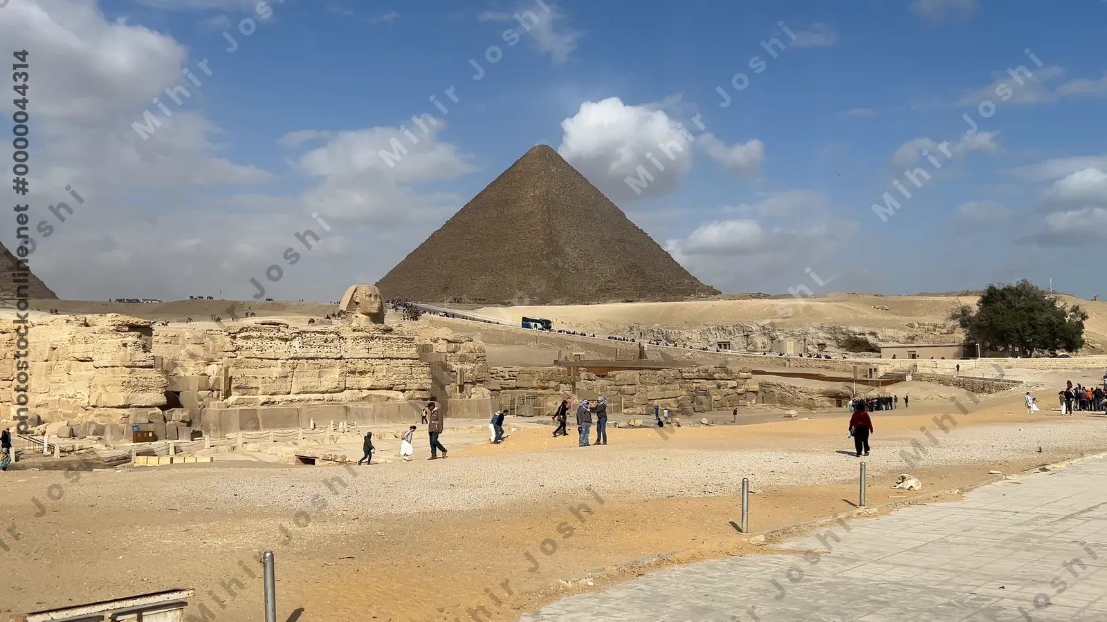 Giza, Egypt - Feb 5, 2025:  View of the Great Sphinx with the Pyramids of Khafre and Khufu in the background at the Giza Plateau, Egypt.