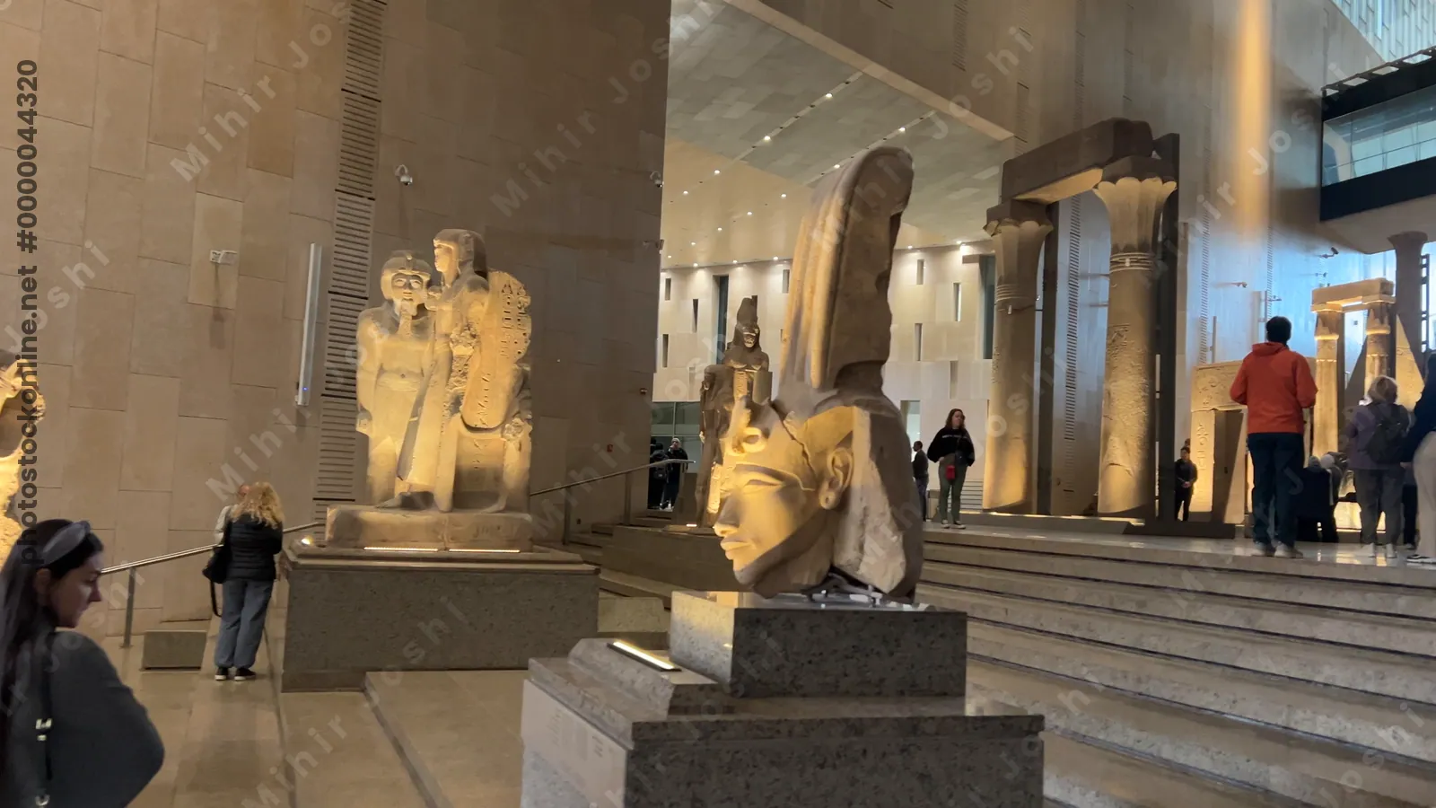 Giza, Egypt - Feb 6, 2025: Video of the Grand Egyptian Museum’s first staircase section, showcasing seated statues and figures in a vertical sculpture gallery.