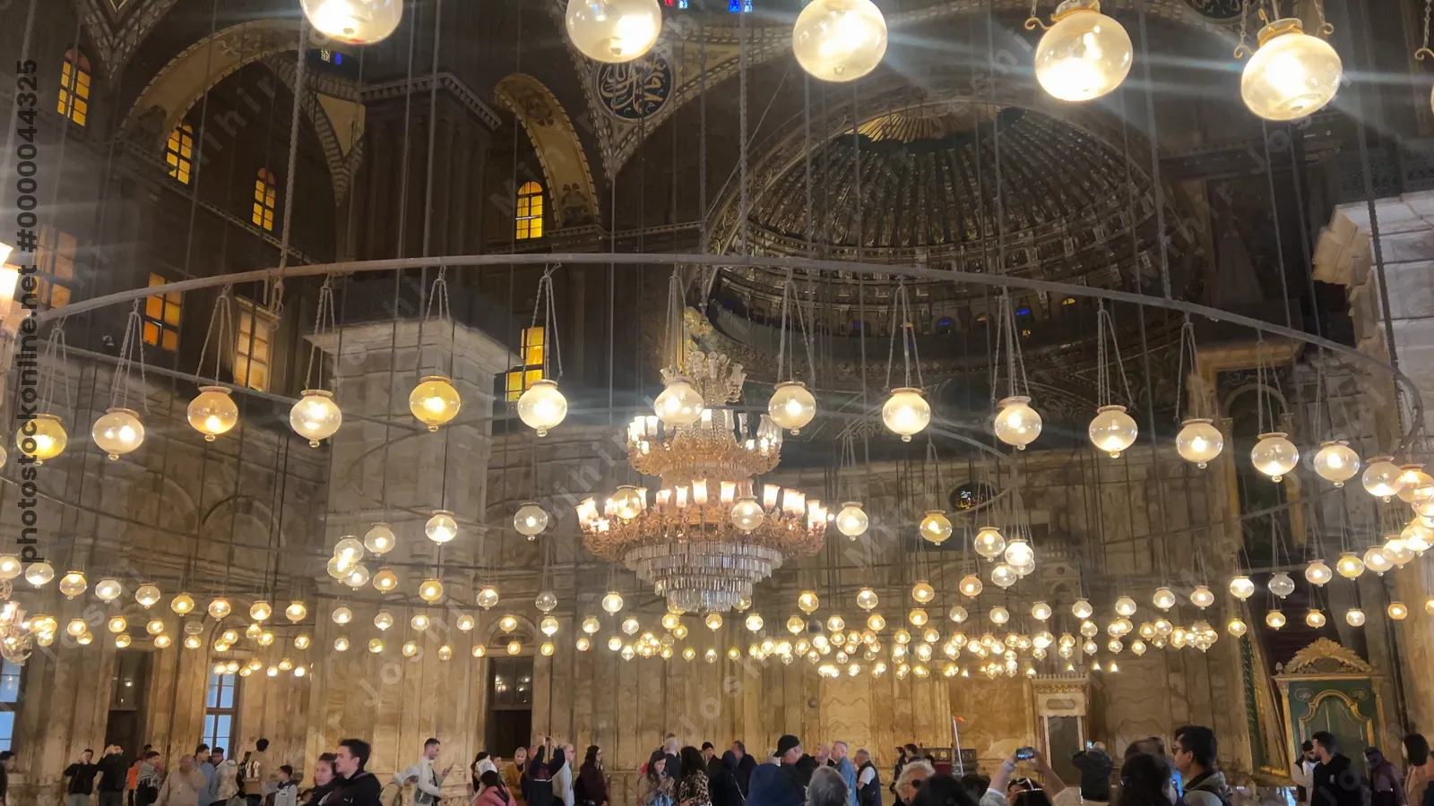 Cairo, Egypt - Feb 6, 2025:  Illuminated interior of the Muhammad Ali Mosque with ornate domes and intricate Islamic designs in Cairo’s historic citadel.