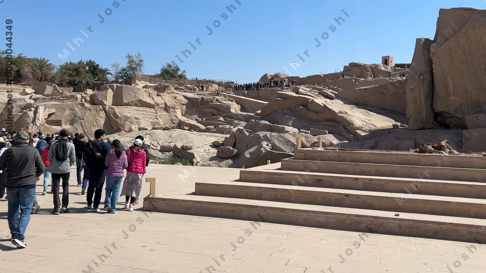 Aswan, Egypt - Feb 7, 2024: Visitors at the archaeological site of the Unfinished Obelisk in Aswan, exploring the ancient granite quarry and historic monument.