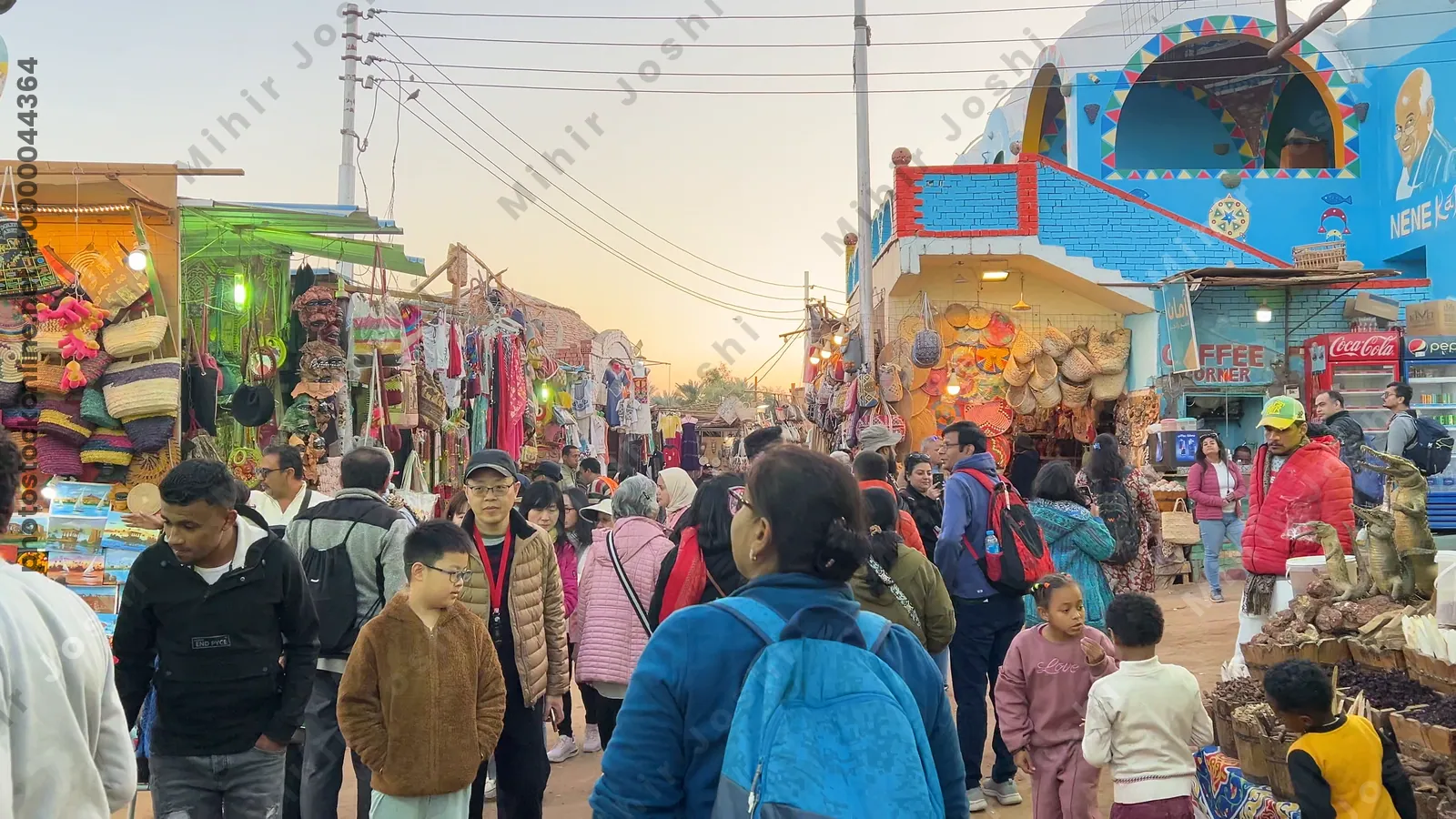 Aswan, Egypt - Feb 7, 2024: Point of view video walking through a colorful market in a Nubian village near Aswan, Egypt, showcasing local shops and culture.