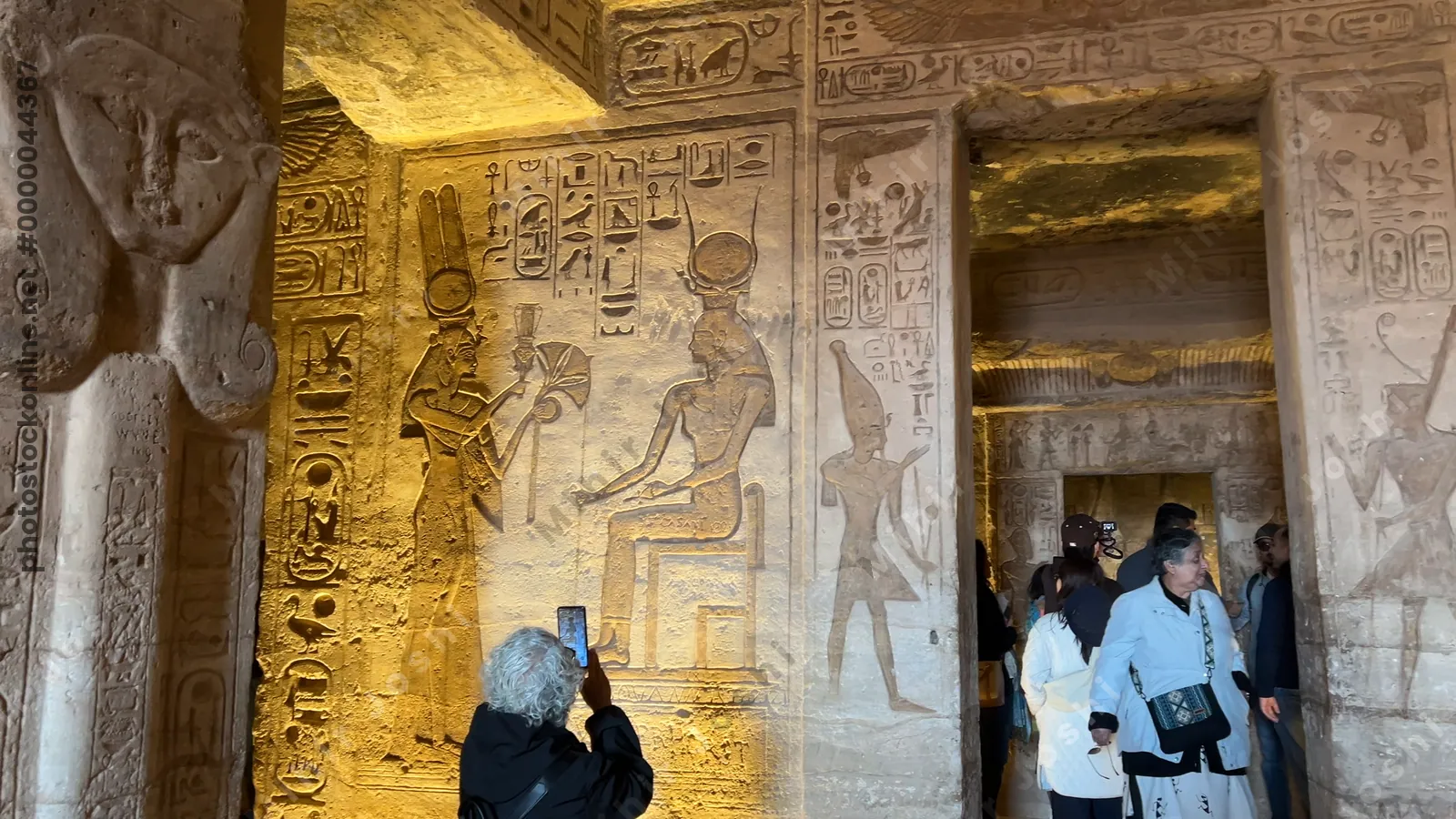 Aswan, Egypt - Feb 8, 2025: Interior relief at the Temple of Nefertari in Abu Simbel, depicting goddess Hathor with Pharaoh Ramesses II.