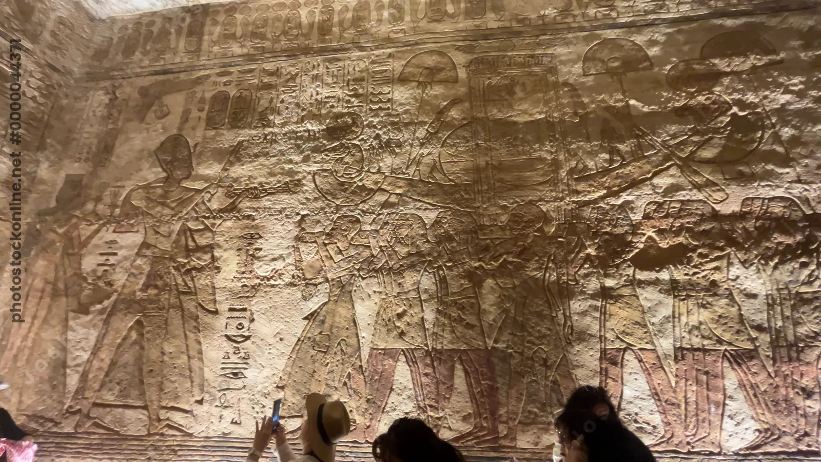 Aswan, Egypt - Feb 8, 2025: Relief at Abu Simbel showing Pharaoh Ramesses II making an offering to the sacred solar barque carried by priests.