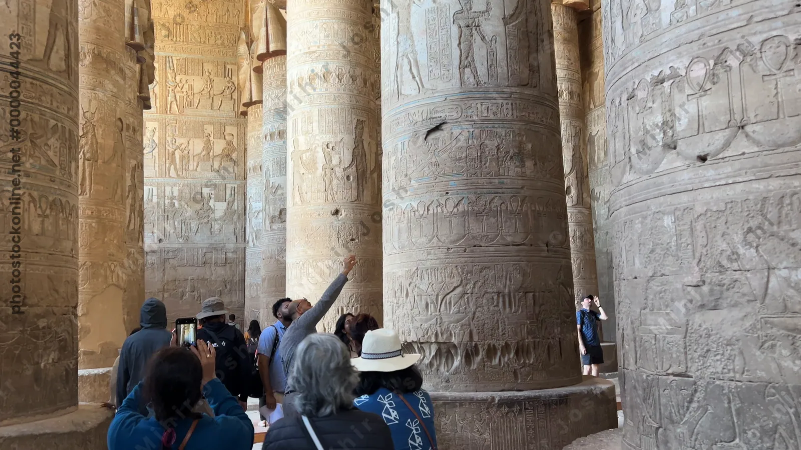 Dendera, Egypt - Feb 10, 2025: Tracking footage walking through massive stone columns decorated with carvings and hieroglyphs inside the Temple of Dendera in Egypt.