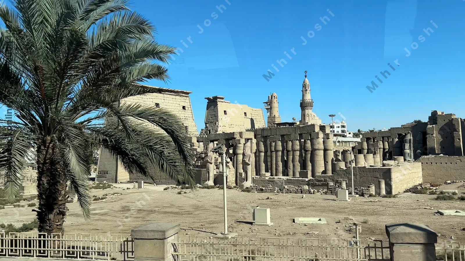 Luxor, Egypt - Feb 10, 2025: Footage of Karnak Temple complex as seen from a moving bus, with ancient ruins and monumental structures in view.