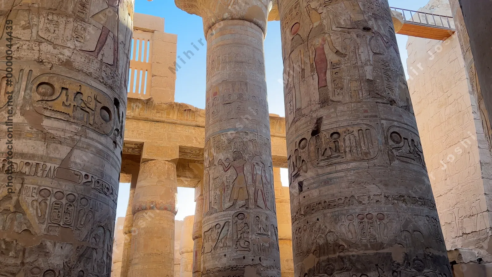 Luxor, Egypt - Feb 10, 2025: Tourists exploring the Hypostyle Hall of Karnak Temple, surrounded by towering sandstone columns decorated with hieroglyphs and relief carvings.