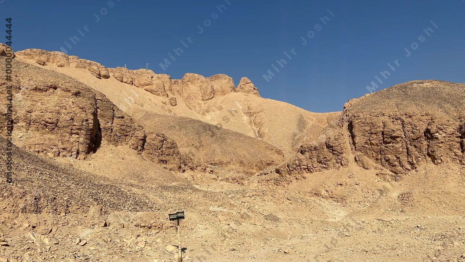 Luxor, Egypt - Feb 11, 2025: Tall cliffs and desert mountains surrounding the Valley of the Kings, the burial site of ancient pharaohs.