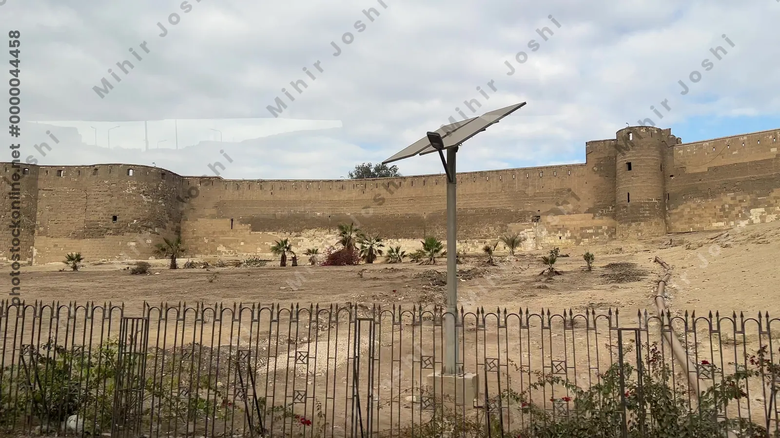 Cairo, Egypt - Feb 12, 2025: Stone walls and towers of the Citadel of Cairo, a medieval Islamic fortress and UNESCO heritage site, viewed while traveling by bus.