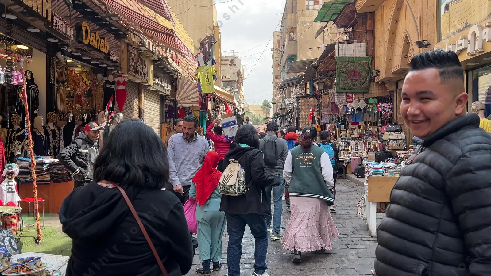 Cairo, Egypt - Feb 12, 2025: Tourists walking through the bustling market stalls and historic shops along al-Mu'izz Street in the heart of Islamic Cairo.